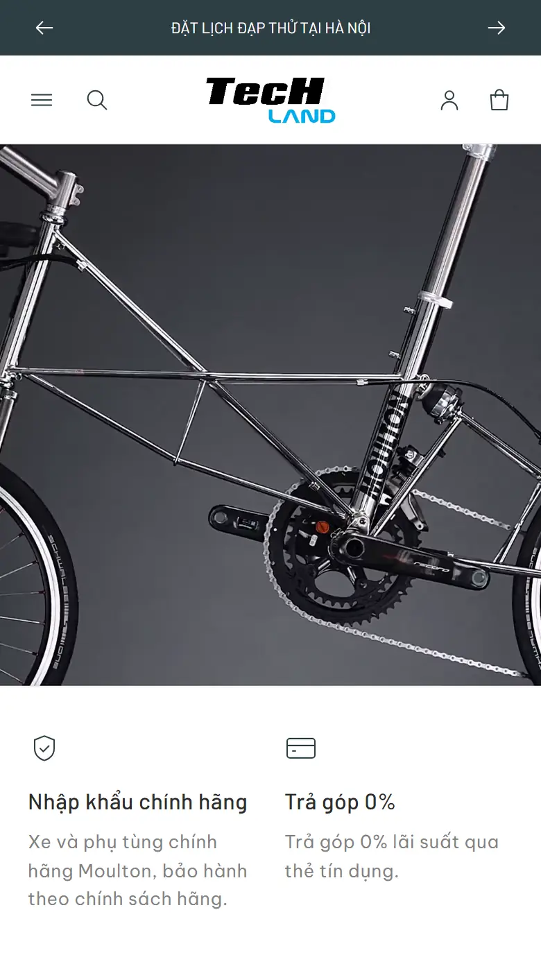 Trang chủ Moulton trên điện thoại: logo TecHland ở giữa, thanh Đặt lịch đạp thử tại Hà Nội, video khung xe chrome và bộ đĩa Campagnolo, bên dưới là hai cam kết Nhập khẩu chính hãng và Trả góp 0%